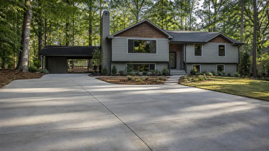 general concrete construction completed by a local contractor at a grey split-level home in Alpharetta, GA, under low winter sun.